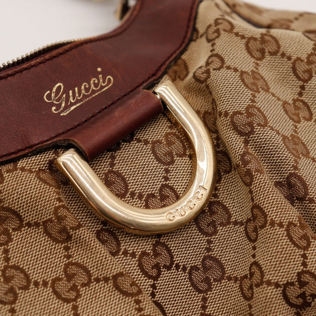 Détail logo Gucci doré et anneau métallique occasion authentique — AMANA Vintage