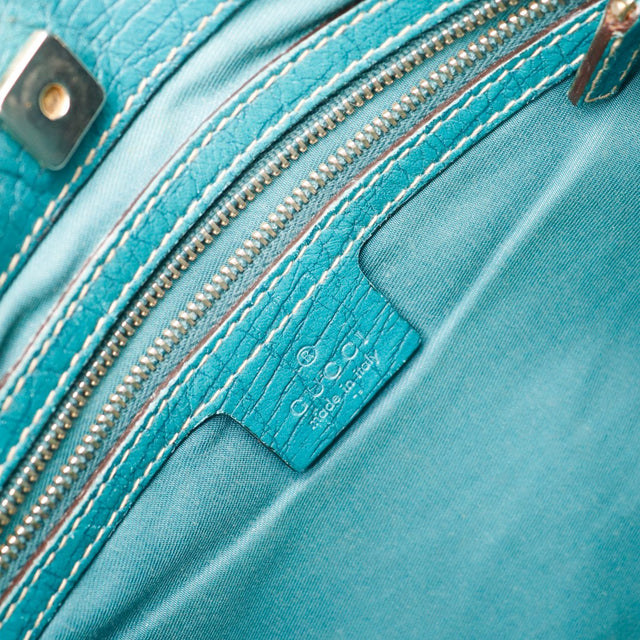 Détail étiquette intérieure Gucci made in Italy doublure turquoise — AMANA Vintage