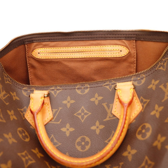 Détail du cadenas doré Louis Vuitton Speedy 35 occasion authentique — AMANA Vintage