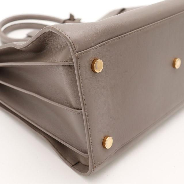 Détail coin inférieur Sac de Jour Grand Saint Laurent pieds dorés — AMANA Vintage