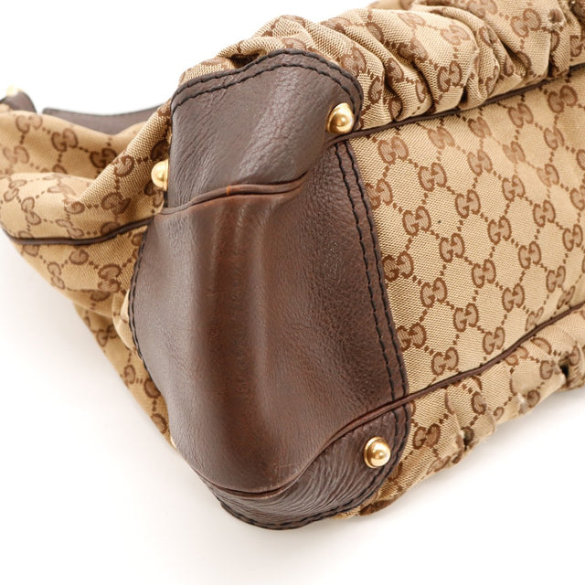 Détail coin inférieur Hobo Gucci cuir marron légers frottements — AMANA Vintage