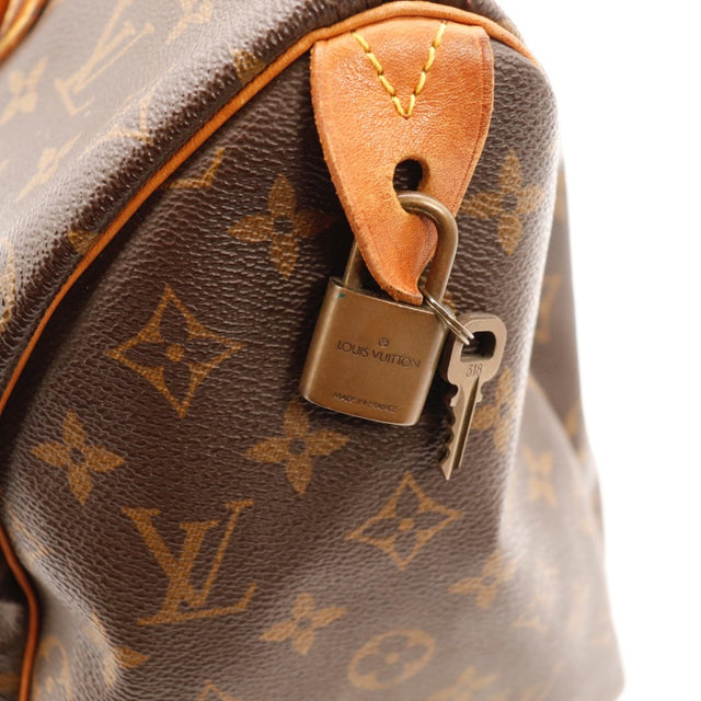 Détail de la fermeture Louis Vuitton Speedy 30 Toile Monogramme occasion authentique — AMANA Vintage