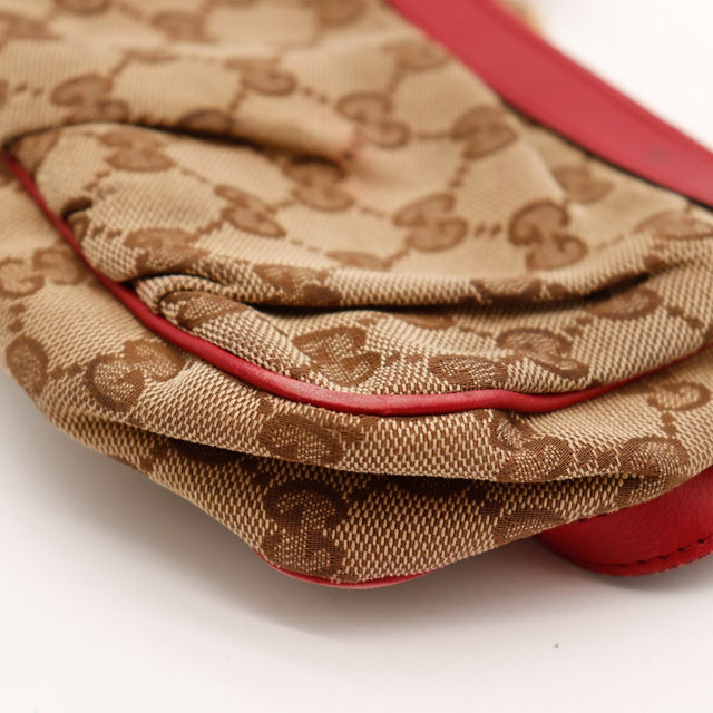 Détail souplesse toile monogrammée Gucci pochette rouge vue rapprochée — AMANA Vintage