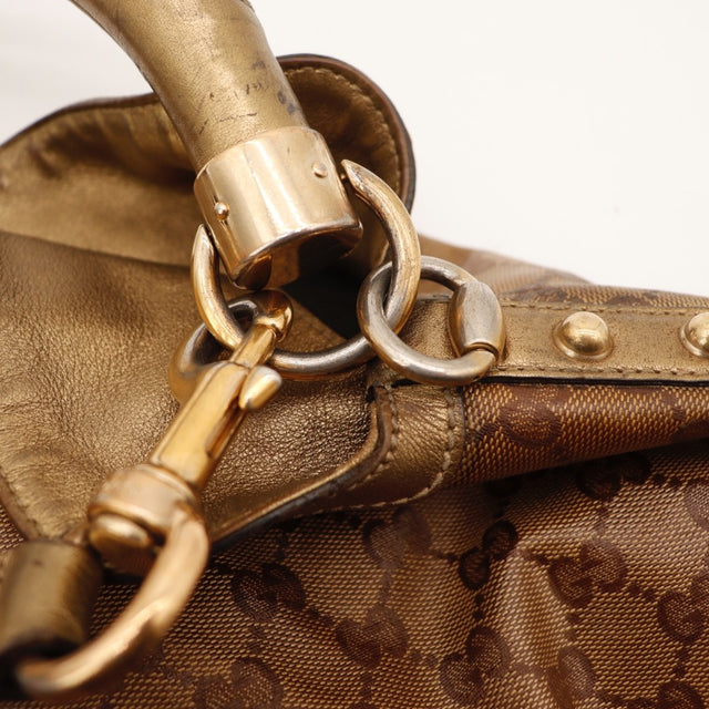 Détail de l'étiquette intérieure Gucci Indy Hobo toile monogrammée bronze occasion authentique — AMANA Vintage