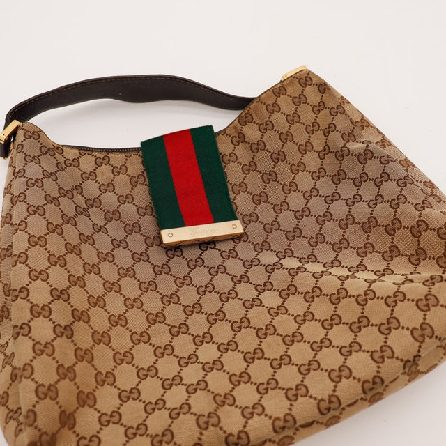 Détail plaque dorée Gucci et bande Web verte rouge sur Hobo Web — AMANA Vintage
