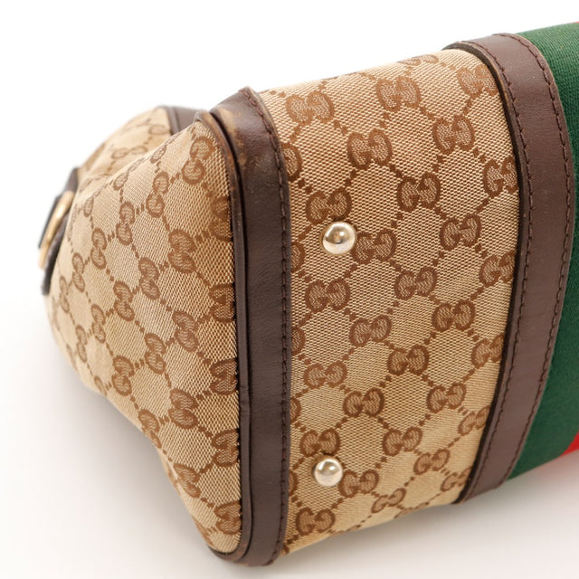 Détail coin bas Gucci Boston Web usure cuir marron — AMANA Vintage