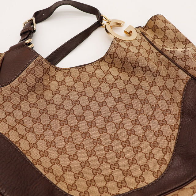 Détail anses et boucles Hobo Gucci cuir marron argenterie dorée — AMANA Vintage