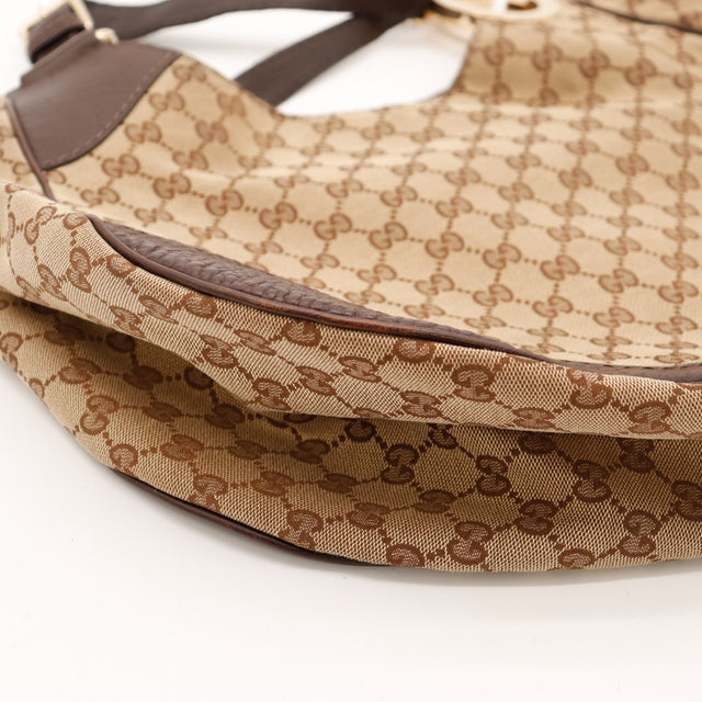 Détail bas gauche Hobo Gucci toile monogrammée jonction cuir marron — AMANA Vintage