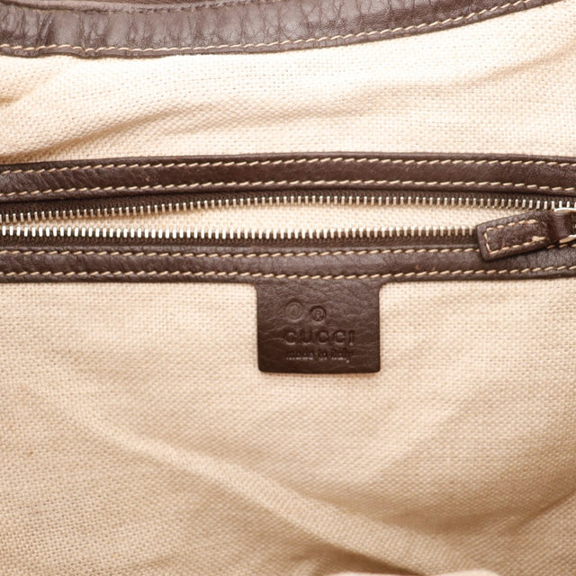Vue de profil Gucci Hobo toile monogrammée beige et ébène occasion authentique — AMANA Vintage