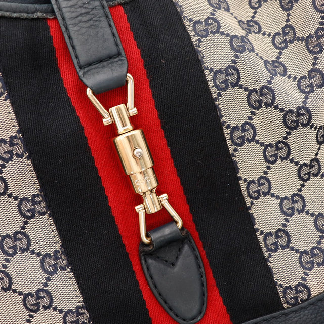 Detail fermoir bambou doré Gucci New Jackie bande web noir rouge — AMANA Vintage