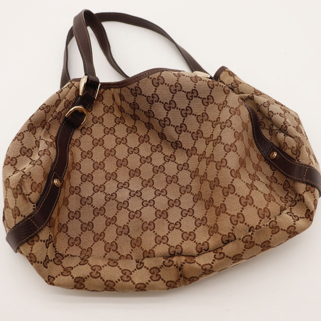 Détail des anses en cuir marron Gucci Hobo toile monogrammée occasion authentique — AMANA Vintage