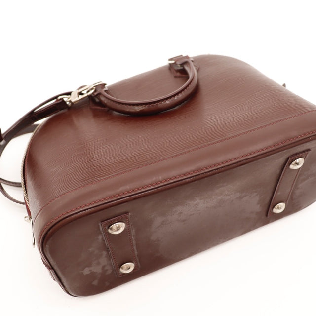 Détail des coins Louis Vuitton Alma PM cuir Épi bordeaux occasion authentique — AMANA Vintage