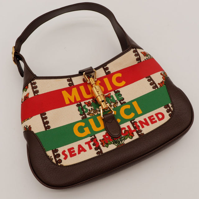 Détail fermoir piston doré Gucci Jackie 1961 occasion authentique — AMANA Vintage