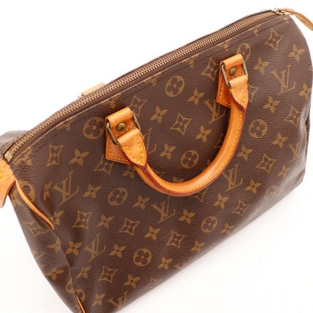 Détail anses Louis Vuitton Speedy 30 cuir vachette patine caramel — AMANA Vintage