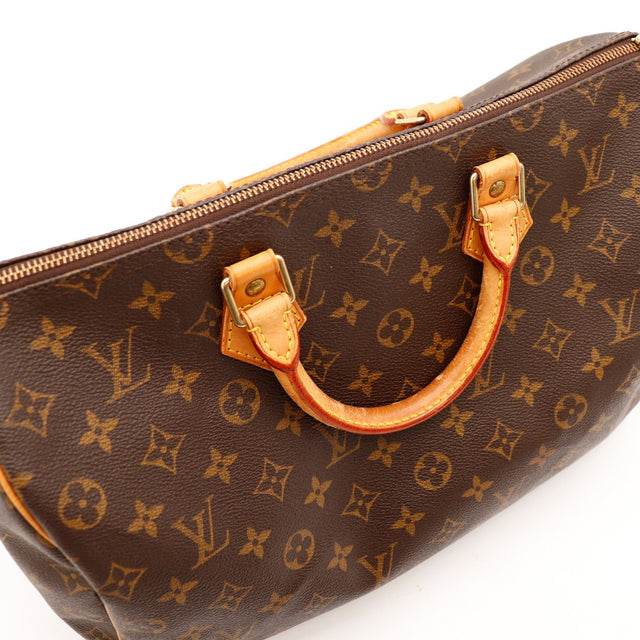 Détail anse cuir vachette patine caramel Louis Vuitton Speedy 35 — AMANA Vintage