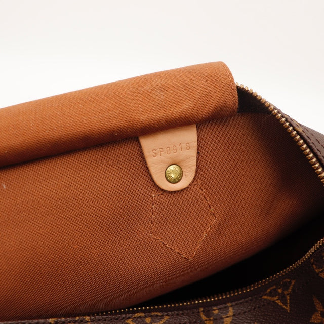 Détail de la fermeture Louis Vuitton Speedy 30 Toile Monogramme occasion authentique — AMANA Vintage