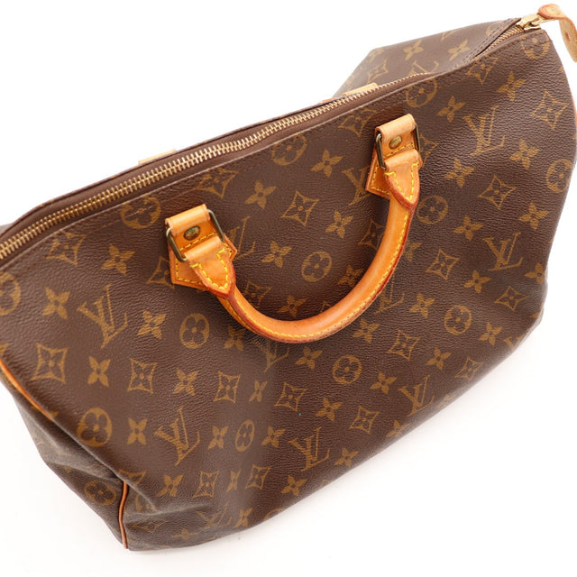 Détail anse et hardware doré Louis Vuitton Speedy 35 vintage — AMANA Vintage