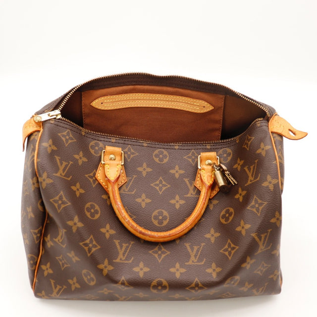 Détail des anses Louis Vuitton Speedy 30 cuir vachette occasion authentique — AMANA Vintage