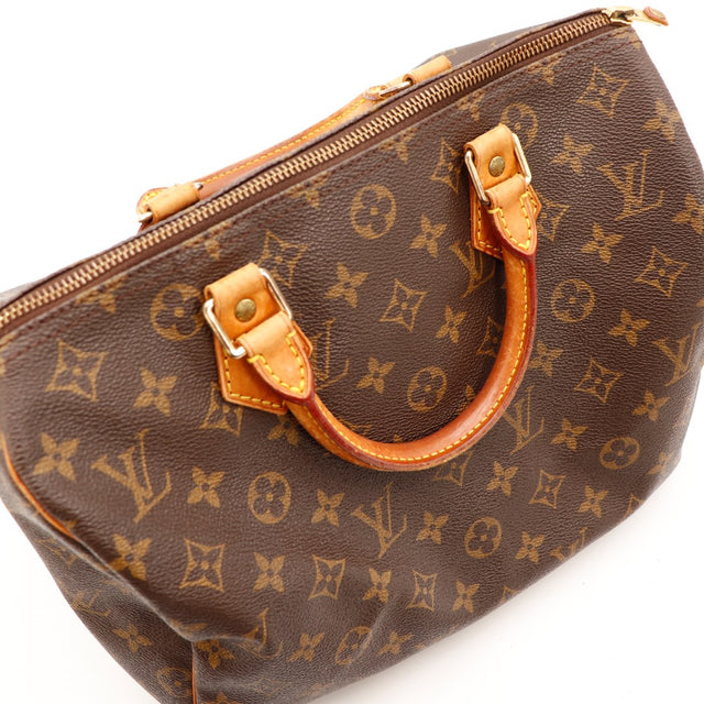 Détail anse et attaches cuir vachette Louis Vuitton Speedy 30 patine caramel — AMANA Vintage