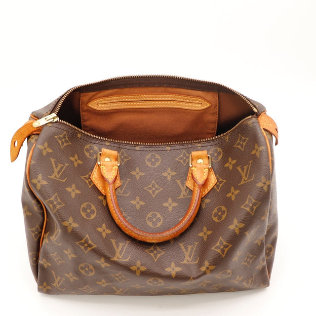Détail de la tirette Louis Vuitton Speedy 30 cuir vachette occasion authentique — AMANA Vintage
