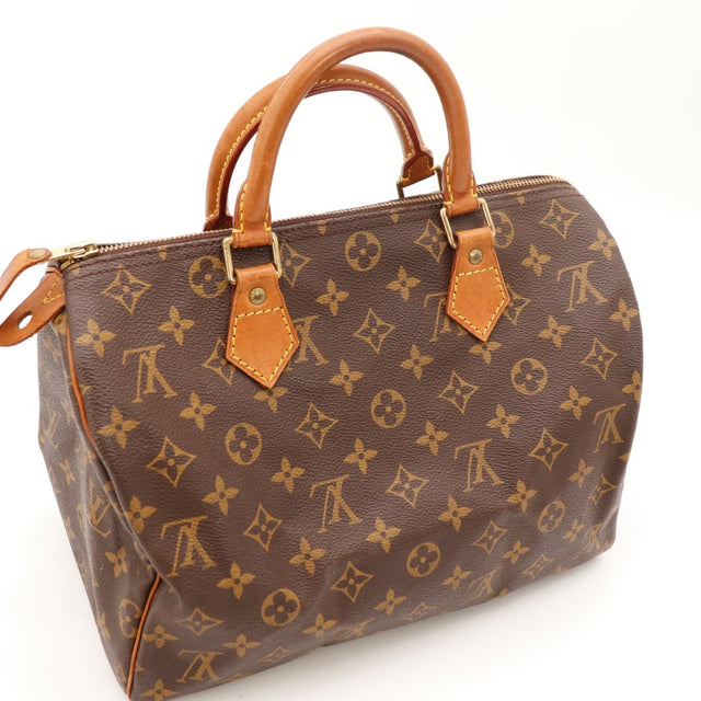 Détail du cadenas et de la clé Louis Vuitton Speedy 30 Toile Monogramme occasion authentique — AMANA Vintage