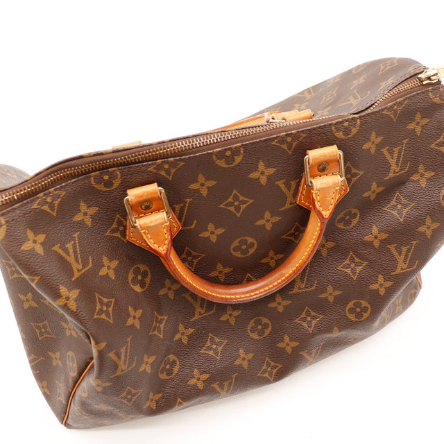 Détail anses cuir vachette Louis Vuitton Speedy 35 patine caramel — AMANA Vintage