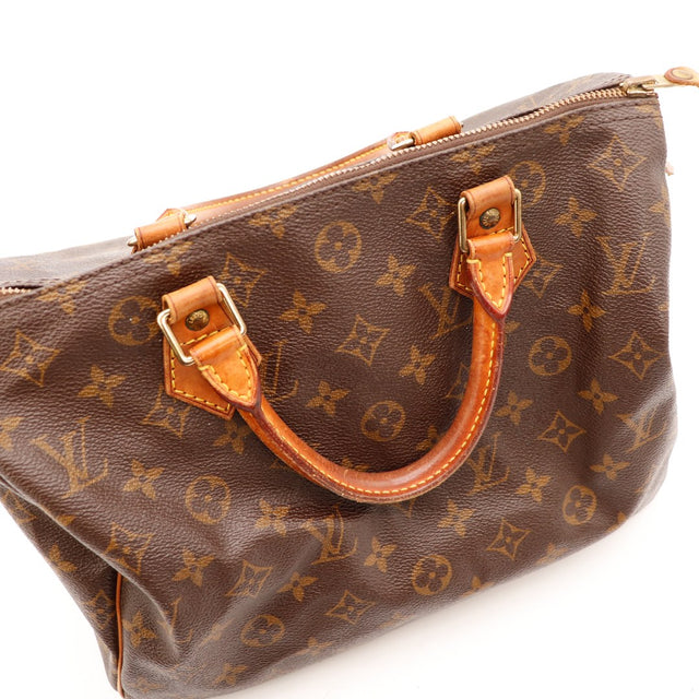 Détail anse et tab vachette patiné Louis Vuitton Speedy 30 — AMANA Vintage