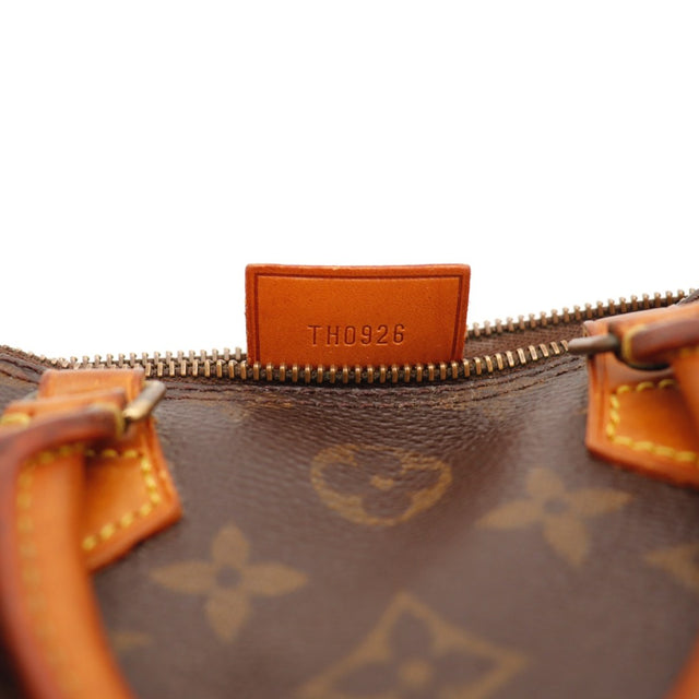 Détail de l'attache de tirette Louis Vuitton Mini Speedy Toile Monogramme occasion authentique — AMANA Vintage