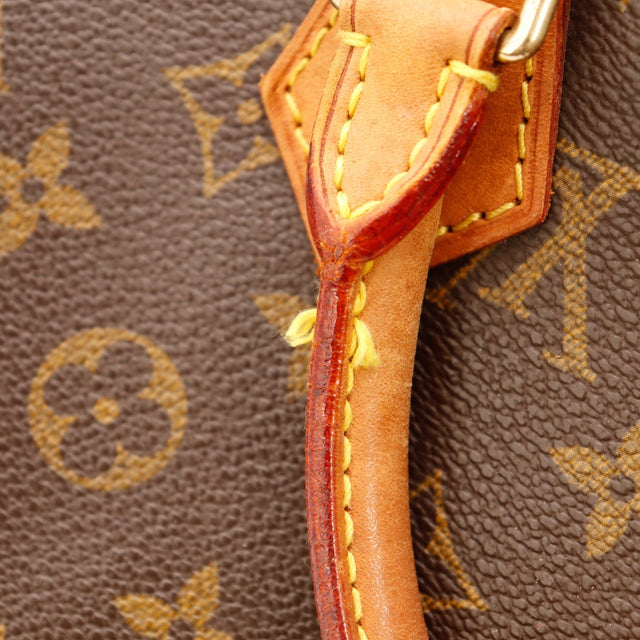 Détail anse cuir vachette base attache Louis Vuitton Speedy 30 patine caramel — AMANA Vintage