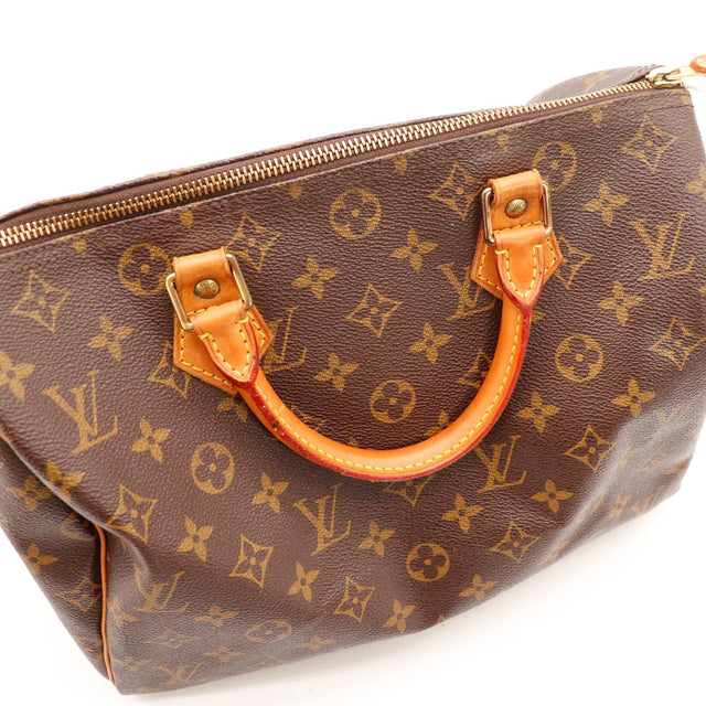 Détail anses vachette patine caramel Louis Vuitton Speedy 30 occasion — AMANA Vintage