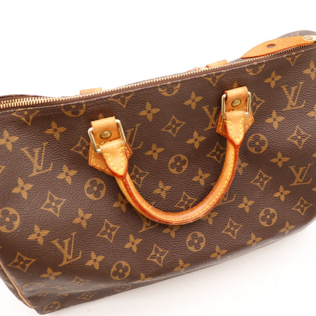 Détail anses cuir vachette Louis Vuitton Speedy 35 patine caramel — AMANA Vintage