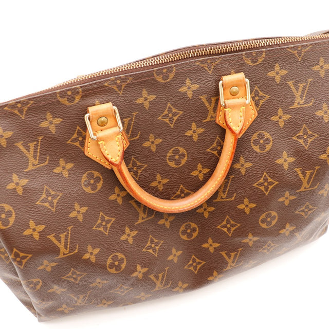 Détail anses et attaches vachette Louis Vuitton Speedy 35 patine caramel — AMANA Vintage