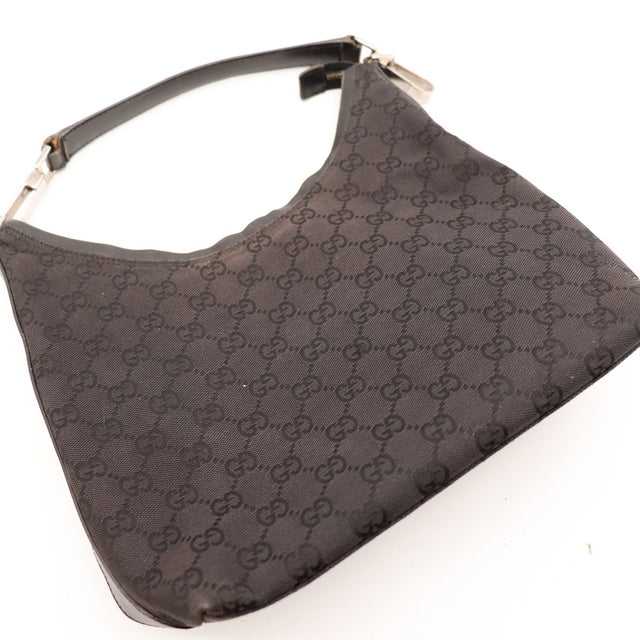 Détail toile monogrammée Gucci noire gros plan — AMANA Vintage