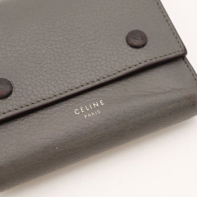 Détail cuir grainé et boutons-pression Céline Paris noir — AMANA Vintage
