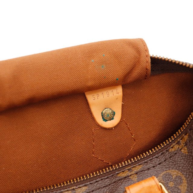 Détail coin et tirette Louis Vuitton Speedy 30 languette cadenas vachette — AMANA Vintage