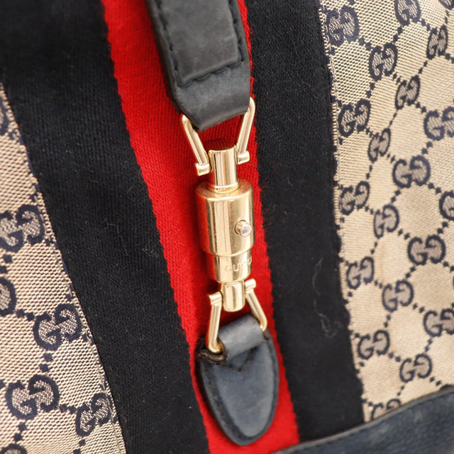 Détail fermoir piston bambou doré Gucci New Jackie bande Web noire rouge — AMANA Vintage