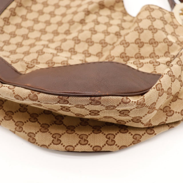 Detail bas sac Gucci Hobo Interlocking G coins cuir marron occasion — AMANA Vintage