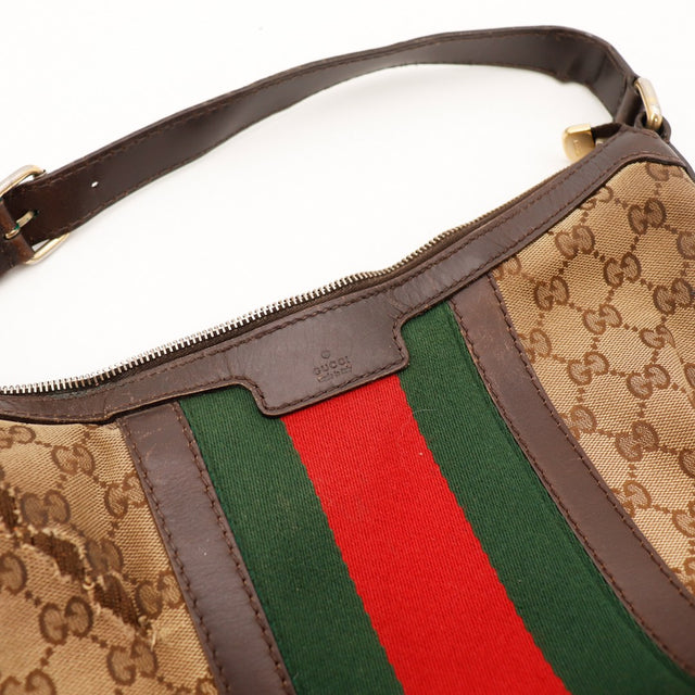 Detail anse et fermeture eclair Gucci Hobo Web cuir marron occasion — AMANA Vintage