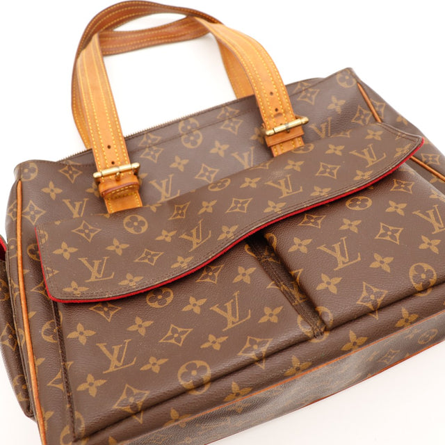 Détail haut du sac Louis Vuitton Multipli Cité anses vachette et boucles dorées — AMANA Vintage