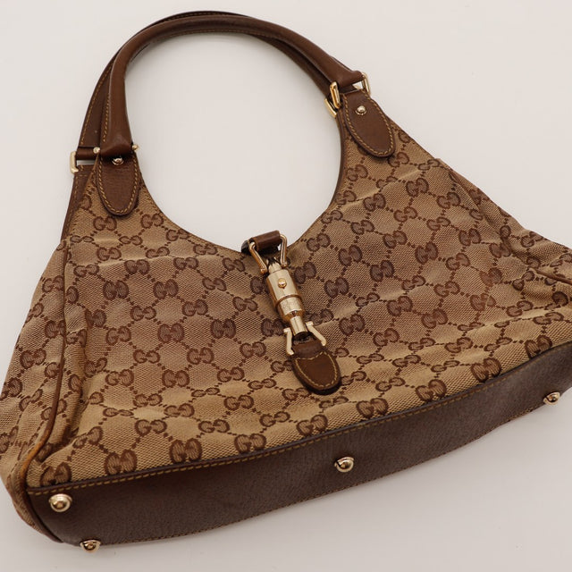 Détail fermoir piston doré Gucci New Jackie toile monogrammée — AMANA Vintage
