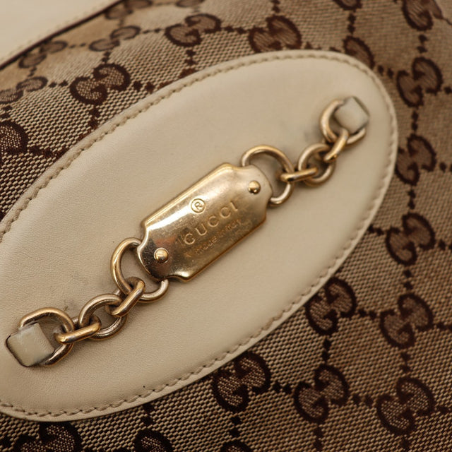 Detail plaque Gucci dore chaine horsebit gros plan — AMANA Vintage