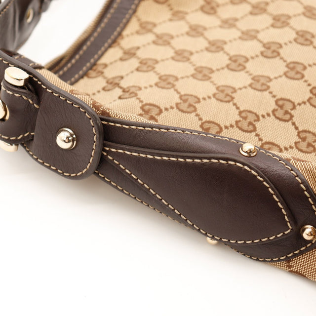Détail anse et rivets Hobo Gucci cuir marron tressé dorure — AMANA Vintage
