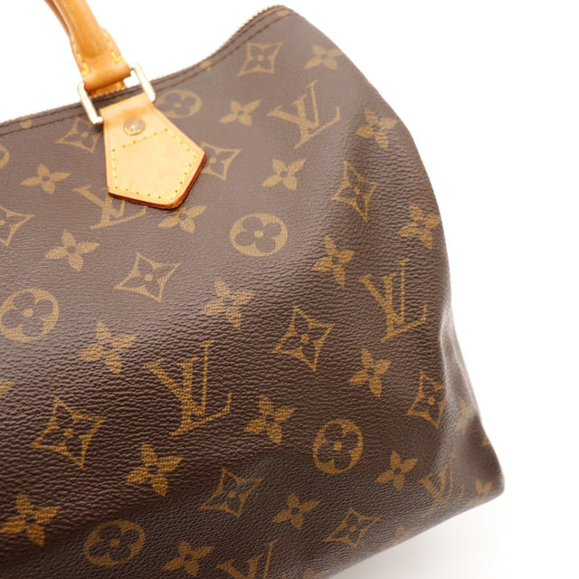 Detail tab vachette Louis Vuitton Speedy 30 patine caramel — AMANA Vintage