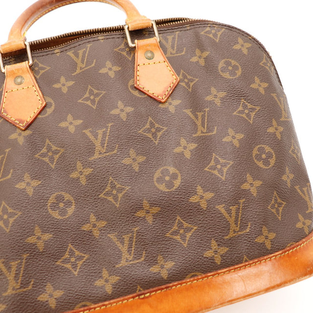 Detail anse Louis Vuitton Alma PM cuir vachette patine caramel occasion — AMANA Vintage