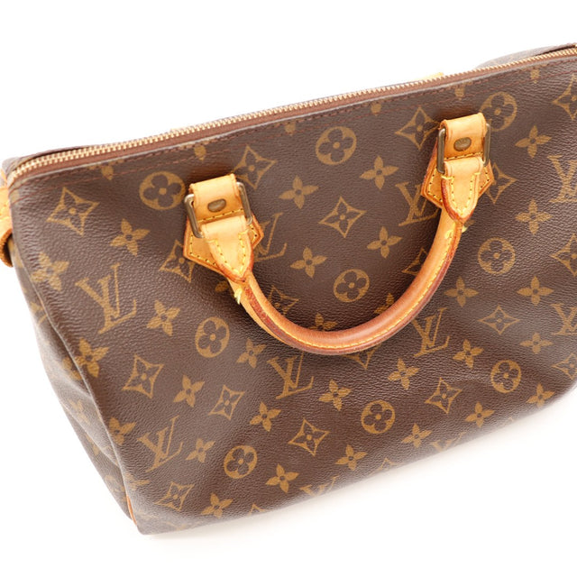 Détail anse et attaches Louis Vuitton Speedy 30 cuir vachette caramel occasion — AMANA Vintage