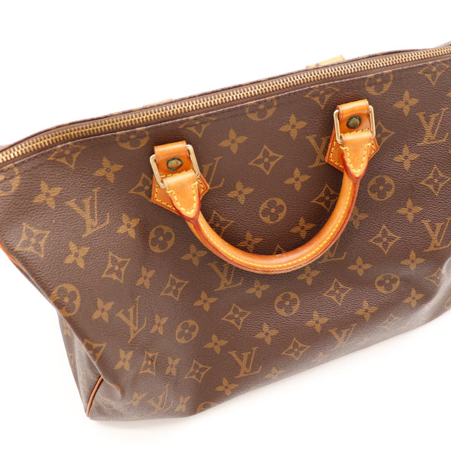 Détail anses et attaches vachette Louis Vuitton Speedy 35 patine caramel — AMANA Vintage