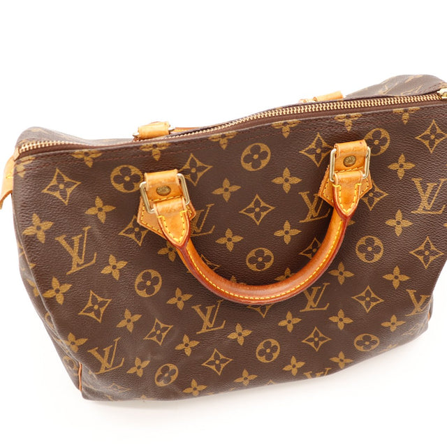 Détail anses et attaches cuir vachette Louis Vuitton Speedy 35 patine caramel — AMANA Vintage