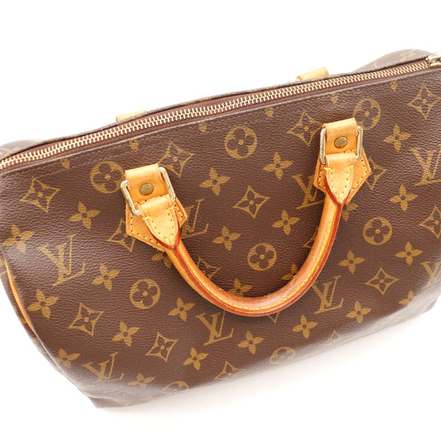 Détail anse et attaches cuir vachette patine caramel Louis Vuitton Speedy 30 — AMANA Vintage
