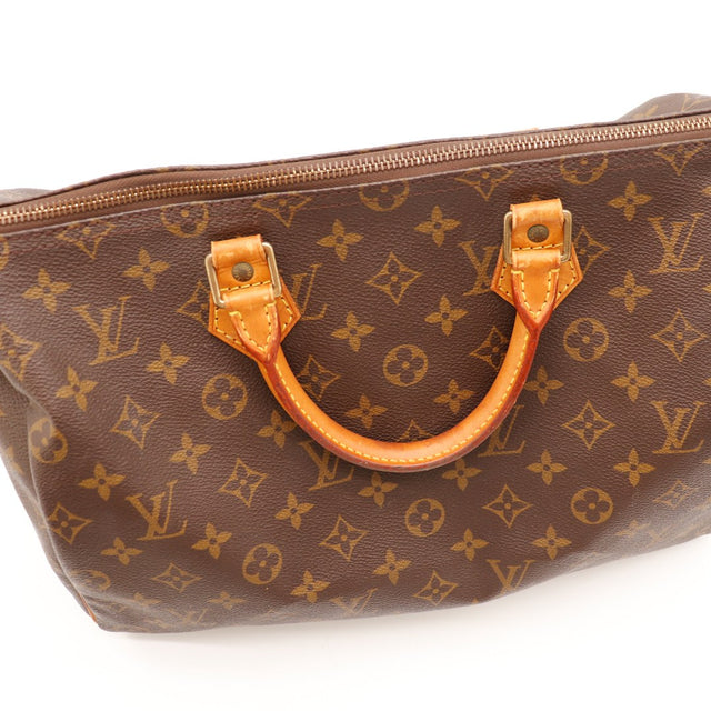 Détail anses et attaches cuir vachette Louis Vuitton Speedy 35 patine caramel — AMANA Vintage