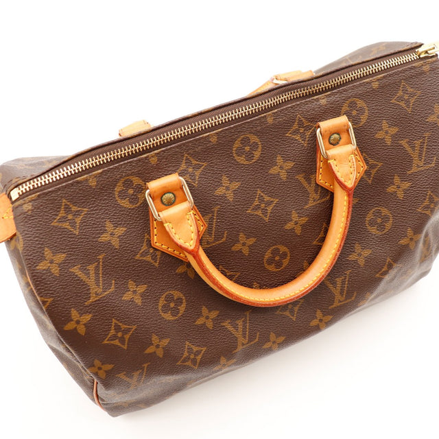 Détail anse et attaches cuir vachette caramel Louis Vuitton Speedy 30 — AMANA Vintage